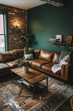 a living room with green walls and leather couches, rugs and coffee table