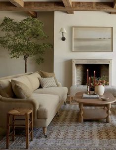 a living room with two couches and a coffee table in front of a fireplace