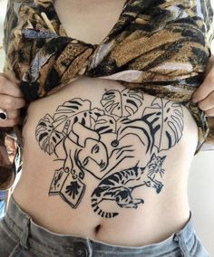 a woman is showing off her stomach with tattoos on it's side and an elephant in the middle