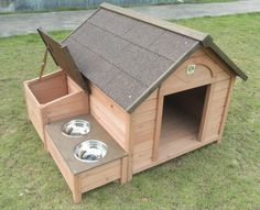 a dog house with two bowls on the outside