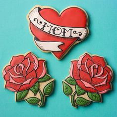 three heart shaped cookies with roses on them