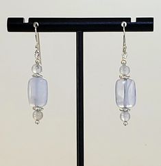 - Stunning Blue Chalcedony Beaded Gemstone Earrings with 925 Sterling Silver Filled accents and 925 Sterling Silver Bali Hook Ear Wires with longer Tails. - Center 4x8mm highly Polished Puff Rectangle Beads with 2 Round 4mm Matching Beads for balance. - Accented by 925 Sterling Silver Plated Bright Twist Heishi Beads and 925 Sterling Silver tiny Round Beads. - 925 Sterling Silver Bali Hook Ear Wires with tiny Ball Ends and 25mm Length longer "Tails" for security. See Photos #1-2. If you want sho Adjustable Drop Earrings With Gemstone Beads, Chalcedony Dangle Earrings With Matching Jewelry, Chalcedony Dangle Jewelry With Matching Earrings, Elegant Earrings With Gemstone Beads, Sterling Silver Gemstone Beads Dangle Earrings, Sterling Silver Gemstone Bead Earrings, Sterling Silver Dangle Earrings With Gemstone Beads, Silver Beaded Earrings With Natural Stones, Silver Earrings With Gemstone Round Beads