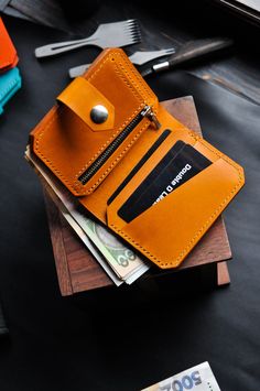 PRODUCT FEATURES  Stylish compact wallet with wide functionality. The accessory does not take up much space and fits in your pocket. The model is suitable for both men, women and children. The product is made of Italian buttero leather from the Walpier factory. It is one of the oldest tanneries in Italy, producing quality vegetable tanned leather. The factory is located in the historic area of Tuscany, where the heart of Italian leather production is located. WALLET FEATURES: * Convenient placem Bifold Coin Purse With Zipper Pocket For Everyday, Everyday Bifold Coin Purse With Zipper Pocket, Bifold Wallet With Zipper Pocket As Gift, Leather Bifold Wallet With Zipper Pouch, Leather Bifold Coin Purse With Zipper, Yellow Leather Wallet For Everyday Use, Modern Wallets With Zipper Pocket For On-the-go, Everyday Orange Leather Wallet, Yellow Leather Rectangular Wallet