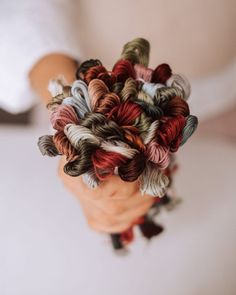 a person holding yarn in their hands