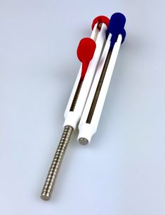 two red, white and blue toothbrushes sitting next to each other