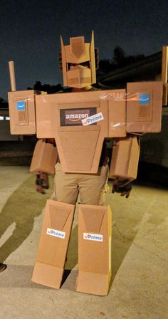 a cardboard robot is standing in the street