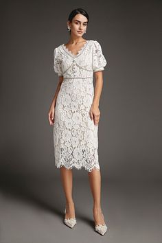 This lace crochet V-neckline midi dress will fill any of your little white dress needs, from your bridal shower to your after party. The textured lace overlay, accented with thick embroidery that outlines the lace’s blooms. Also features puff sleeves and delicate scalloped eyelash lace hem. The rhinestone trim and buttons adds an extra glitz and glam. No Stretch Medium Weight Size runs small,recommend one size up Fabric: 100% Polyester,Lining: 100% Polyester Model is 174cm/5'7" tall, 81cm/32" bust, 61cm/24" waist and 90cm/35" hip and wears a size S. Care Instruction: Hand Wash, Do not bleach, Dry flat in shade, Iron cool (max 110â„?, Dry clean, tetrachloroethylene(PCE) only.Please note: The images represent actual product though color of the image and product may slightly differ. This item Delicate Lace V-neck Dress For Brunch, Elegant Lace Midi-length Mother Of The Bride Dress, Fitted V-neck Lace Dress For Wedding Guest, Elegant Midi Dress With Delicate Lace For Party, Elegant Party Midi Dress With Delicate Lace, Tea Length Lace Dress For Formal Occasions, Formal Tea Length Lace Dress, Elegant Lace Midi Dress With Scalloped Lace, Elegant Lace Midi Dress With Delicate Lace