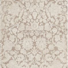 a beige rug with an intricate design on the top and bottom part of it's surface