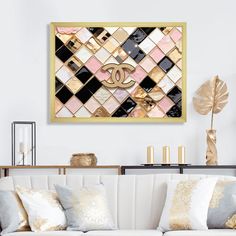 a living room with white couches and gold accents on the wall above it is a chandelier