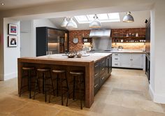 a kitchen with an island and lots of stools