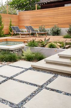 an outdoor patio with stone steps and seating area