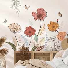 a bedroom with flowers and butterflies painted on the wall