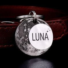 the lunaa key chain is attached to a leather belt