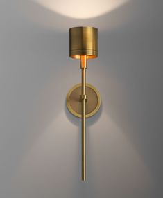 a wall light with a round shade on it