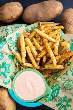 french fries and dip on a plate with potatoes