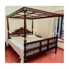 a four poster bed in a bedroom with tile flooring