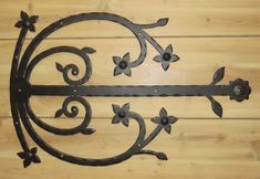 a metal wall hanging on the side of a wooden floor