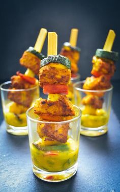 small glasses filled with food on top of a table