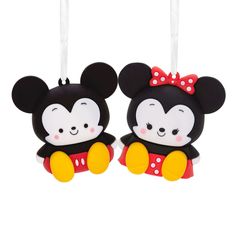 two mickey and minnie mouse ornaments hanging from strings