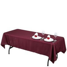 the table is set with two wine glasses on it