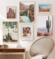 there are many pictures hanging on the wall next to a wicker chair and table