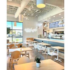 the inside of a restaurant with tables and chairs