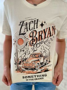 a person wearing a t - shirt that says zach and bryan something in the orange