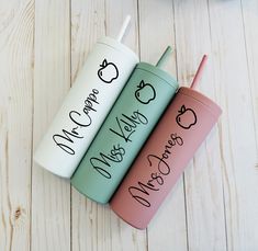 three personalized tumblers sitting on top of a white wooden floor next to each other