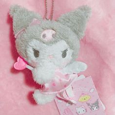 a stuffed animal with a pink tag on it's neck and a keychain attached to it