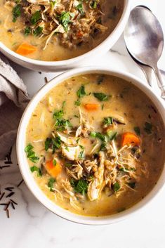 two bowls filled with soup on top of a table