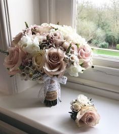 a bouquet of flowers sitting on top of a window sill