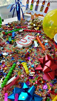 the birthday cake is surrounded by confetti and streamers