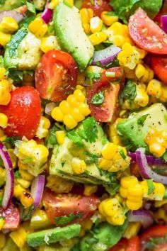 a salad with tomatoes, corn and avocado