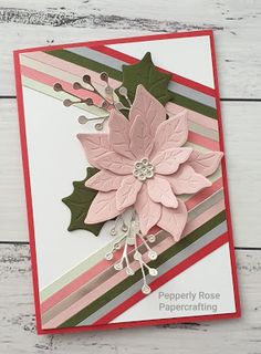 a close up of a card with a poinsettia on the front and bottom