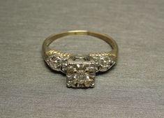 a ring with three diamonds on it sitting on a table