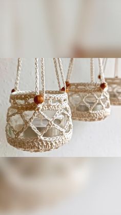 three small baskets hanging from strings with beads