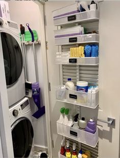 a washer and dryer in a room with shelves on the wall next to each other