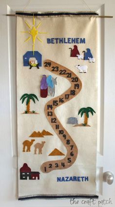 a hand made wall hanging with the names and numbers of different animals, trees, and houses