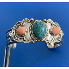 * Designer Reve 925 Sterling Silver Turquoise Coral Statement Open Cuff Bracelet * Inner Cuff Measures: 5-1/8" * Gap Measures: 1-1/2" * Width: 1.0" * One Oval Turquoise Cabochon Measures Approximately 18.0 Mm X 12.5 Mm X 5.0 Mm * Two Oval Coral Cabochons Measure Approximately 9.5 Mm X 8.5 Mm X 5.0 Mm Each * Bracelet Weight: 52.6 Tgw * Marked: Reve * Sterling * Condition: As Pictured. (Zdt225br) * S5403 Elegant Turquoise Sterling Silver Oyster Bracelet, Luxury Sterling Silver Turquoise Bracelet, Luxury Turquoise Sterling Silver Bracelets, Elegant Turquoise Cuff Bracelet With Natural Stones, Open Cuff Bracelet, Coral Turquoise, Silver Turquoise, Turquoise Sterling Silver, Womens Jewelry Bracelets