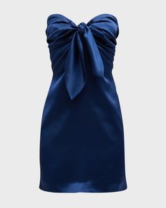 Crafted from high-quality satin, this strapless navy blue dress features a bodycon silhouette and a corset bodice with a tie-front, adding a touch of elegance and sophistication. The ruched details and zip-up back provide a flattering fit, keeping you comfortable and confident all day long. With a built-in bra for adde Strapless Dress Homecoming, Short Blue Formal Dress, Strapless Blue Prom Dress, Blue Tight Short Dress, Homecoming Dresses Navy, Tight Short Dress, Dress Bow Tie, Hoco Inspo, Mini Homecoming Dress