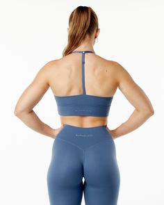 HIGHLIGHTS. Brushed on inside and outside. Mid chest front neckline style. High waistband. Adjustable straps. Moisture-wicking fabric. Alphalete core wordmark logo in tonal raised silicone. Longline. Medium to low impact and includes removable cups FIT SUGGESTION. This item runs true to Alphalete’s standard fit.. If you are between sizes, we recommend sizing up for a relaxed fit and down for a body-con fit. Model is 5’5”/165cm, wearing a size S with a 32”/81cm bust. MATERIALS AND WASHING DIRECTI Solid Recycled Polyester Sports Bra For Training, Solid Color Recycled Polyester Sports Bra For Training, Solid Activewear With Adjustable Straps For Training, Blue Sports Bra With Built-in Padding And 4-way Stretch, Micro-elastic Blue Sports Bra For Sports, Blue Seamless Nylon Sports Bra, Blue Medium Support Nylon Sports Bra, Blue Nylon Sports Bra With Medium Support, Blue Racerback Sports Bra With Adjustable Straps