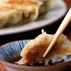 some food in a bowl with chopsticks sticking out of it