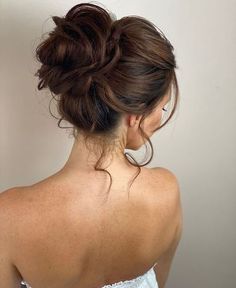 a woman with her hair in a low bun