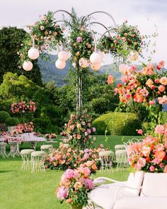 an outdoor wedding setup with flowers and chairs