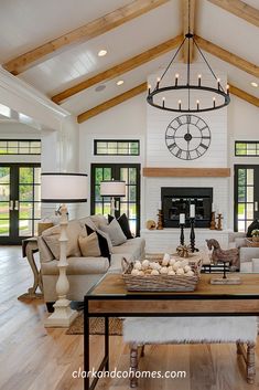 a living room filled with furniture and a large clock mounted to the wall above it