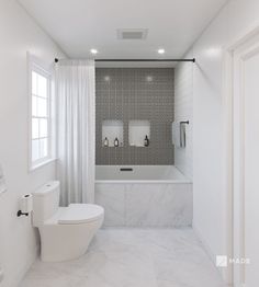 a white bathroom with marble flooring and walls