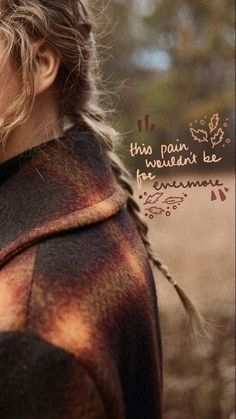 a woman with braids on her hair standing in a field