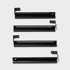 three black shelf brackets on a white background