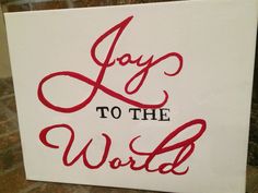 a sign that says joy to the world in red ink on white paper with black lettering