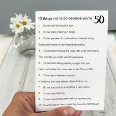 a person holding up a sign that says 10 things not to do because you're 50